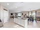 Kitchen island with granite countertops and white cabinets; open to the living area at 36811 N El Morro Trl, San Tan Valley, AZ 85140