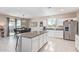 Open concept kitchen with island, white cabinets, and granite countertops at 36811 N El Morro Trl, San Tan Valley, AZ 85140