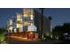 Night view of modern multi-level building with lit windows and landscaping at 3707 N Marshall Way # 3, Scottsdale, AZ 85251