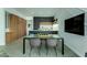 Modern kitchen with wood and dark cabinetry, features a glass dining table at 3707 N Marshall Way # 3, Scottsdale, AZ 85251