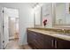 Bathroom featuring granite countertops, double sinks, and dark wood cabinetry at 37222 N Tom Darlington Dr # 11, Carefree, AZ 85377