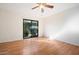 Bedroom featuring wood floors, a ceiling fan, and sliding glass door to the backyard at 37222 N Tom Darlington Dr # 11, Carefree, AZ 85377