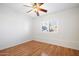 Sunlit bedroom featuring wood floors, a ceiling fan, and bright window at 37222 N Tom Darlington Dr # 11, Carefree, AZ 85377