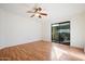 Comfortable bedroom featuring wood floors, a ceiling fan, and sliding glass door to the backyard at 37222 N Tom Darlington Dr # 11, Carefree, AZ 85377