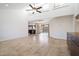 Bright living room featuring neutral tile flooring, high ceilings, and sliding door access to the backyard at 37222 N Tom Darlington Dr # 11, Carefree, AZ 85377