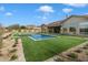 Expansive backyard with a refreshing pool and lush green lawn at 3750 N Piedra Cir, Mesa, AZ 85207