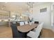 Bright dining room features a large wooden table with seating for six and an elegant light fixture at 3750 N Piedra Cir, Mesa, AZ 85207