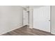 Bedroom with double door closet and wood-look floors at 3905 S 185Th Ln, Goodyear, AZ 85338