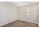 Bright bedroom with wood-look floors and window blinds at 3905 S 185Th Ln, Goodyear, AZ 85338