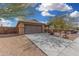 House exterior showcasing a brown garage door, stone accents, and a driveway at 3905 S 185Th Ln, Goodyear, AZ 85338