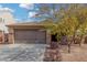 House exterior with a brown garage door, stone accents, and landscaping at 3905 S 185Th Ln, Goodyear, AZ 85338