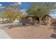 House exterior featuring a brown garage door, stone accents, and landscaping at 3905 S 185Th Ln, Goodyear, AZ 85338