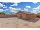 Tan house exterior with a covered patio and grassy yard at 3905 S 185Th Ln, Goodyear, AZ 85338