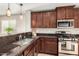 Modern kitchen with stainless steel appliances and granite countertops at 3905 S 185Th Ln, Goodyear, AZ 85338