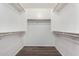 Spacious walk-in closet with wood shelving and rods at 3905 S 185Th Ln, Goodyear, AZ 85338