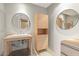 Modern bathroom with floating vanity and circular mirrors at 4200 N Miller Rd # 526, Scottsdale, AZ 85251