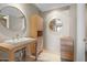 Modern bathroom with floating vanity and circular mirrors at 4200 N Miller Rd # 526, Scottsdale, AZ 85251