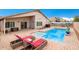 Spacious backyard with refreshing pool, patio furniture, and a tranquil ambiance at 42276 W Chisholm Dr, Maricopa, AZ 85138