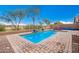 Serene backyard pool area, perfect for relaxation and recreation at 42276 W Chisholm Dr, Maricopa, AZ 85138