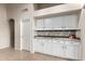 White shaker cabinets and granite countertops in kitchen at 42276 W Chisholm Dr, Maricopa, AZ 85138