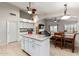 Kitchen island with granite countertops and white cabinets at 42276 W Chisholm Dr, Maricopa, AZ 85138