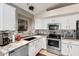 Modern kitchen featuring granite countertops and stainless steel appliances at 42276 W Chisholm Dr, Maricopa, AZ 85138