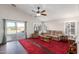 Relaxing living room with pool view and red carpet at 42276 W Chisholm Dr, Maricopa, AZ 85138