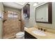 Bathroom featuring tiled shower, toilet and vanity with granite countertop at 43006 N 3Rd Ave, New River, AZ 85087