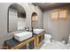 Modern bathroom featuring dual sinks, decorative cabinets, and stylish mirrors at 43006 N 3Rd Ave, New River, AZ 85087