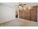 Bedroom with built in cabinets and adjacent bathroom with a vanity at 43006 N 3Rd Ave, New River, AZ 85087