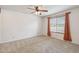 Bedroom featuring neutral carpet, ceiling fan and window with sheer drapes at 43006 N 3Rd Ave, New River, AZ 85087