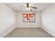 Bedroom featuring neutral carpet, ceiling fan and window with sheer curtains at 43006 N 3Rd Ave, New River, AZ 85087