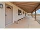 Covered porch features desert landscaping and a neutral color scheme at 43006 N 3Rd Ave, New River, AZ 85087