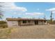 Exterior shot of a single story home featuring a covered porch with desert landscape at 43006 N 3Rd Ave, New River, AZ 85087