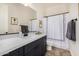 Modern bathroom with dark vanity and white quartz countertop at 4368 E Estrella Ct, Gilbert, AZ 85296