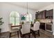 Elegant dining area with seating for six and built-in wine rack at 4368 E Estrella Ct, Gilbert, AZ 85296