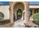 Elegant entryway with a wrought iron door and stone accents at 4368 E Estrella Ct, Gilbert, AZ 85296