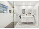 Modern bathroom with white cabinets, double vanity, and large glass shower at 4376 E Anderson Dr, Phoenix, AZ 85032