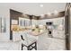 Modern kitchen with white cabinets, granite island, and stainless steel appliances at 4376 E Anderson Dr, Phoenix, AZ 85032