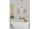 Relaxing bathroom with soaking tub and chandelier at 4501 E Paradise Ln, Phoenix, AZ 85032