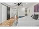 Primary bedroom with wood floors, barn door, and ceiling fan at 4501 E Paradise Ln, Phoenix, AZ 85032