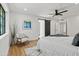 Primary bedroom with wood floors, barn door, and ceiling fan at 4501 E Paradise Ln, Phoenix, AZ 85032