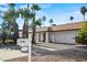 White single story home with a two-car garage and desert landscaping at 4501 E Paradise Ln, Phoenix, AZ 85032