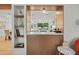 Modern kitchen with island and open shelving; view from living room at 4501 E Paradise Ln, Phoenix, AZ 85032