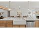 Kitchen island with farmhouse sink and gold fixtures at 4501 E Paradise Ln, Phoenix, AZ 85032