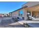 Covered patio with seating area and desert landscaping at 4557 W Agave Ave, Eloy, AZ 85131