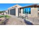 Backyard with patio, seating area and partial view of house at 4557 W Agave Ave, Eloy, AZ 85131