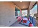 Covered patio with red bench, table and decorative rug at 4557 W Agave Ave, Eloy, AZ 85131