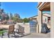 Outdoor kitchen with stainless steel appliances and seating at 4557 W Agave Ave, Eloy, AZ 85131