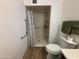 Bathroom with a walk-in shower, grab bars, and toilet at 4624 E Emerald Ave, Mesa, AZ 85206